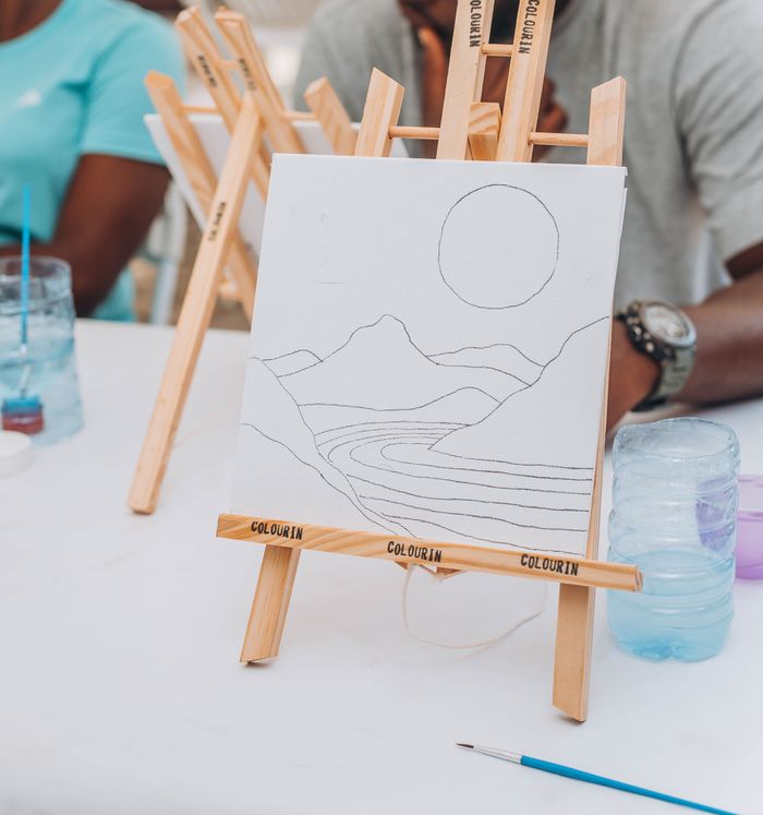 Home Easel with an abstract landscape sketch in a group art class setting.